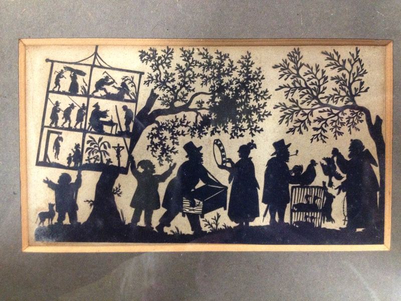 Cut paper picture of a group of six people under trees, probably British, c.1820-1840