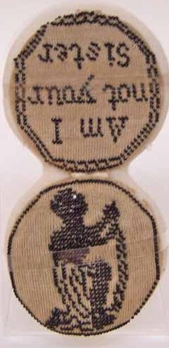 1922.895 Pincushion inscribed with the words 'Am I Not Your Sister' and the figure of a kneeling chained woman.