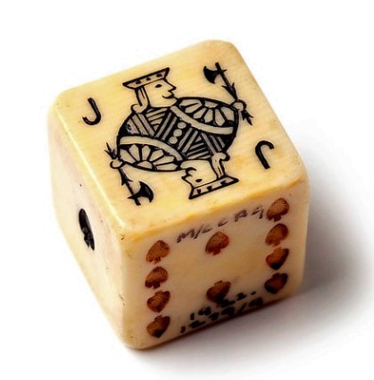 1922.1279 Poker dice, printed with King, Queen, Jack, 10, 9 and Ace of Spades, date unknown.