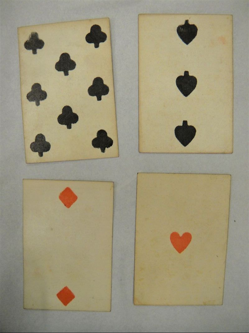 Four cards from set of playing cards, wood-block printed, showing the four different suits.