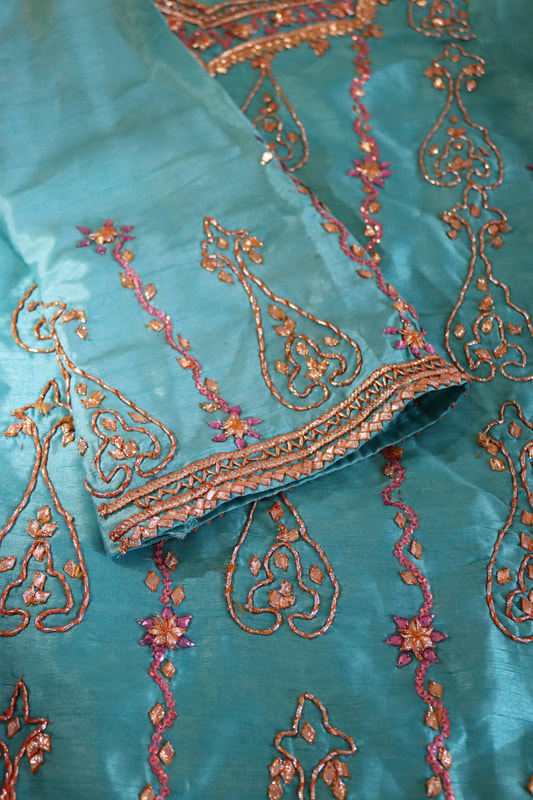 Gold embroidery on blue dress