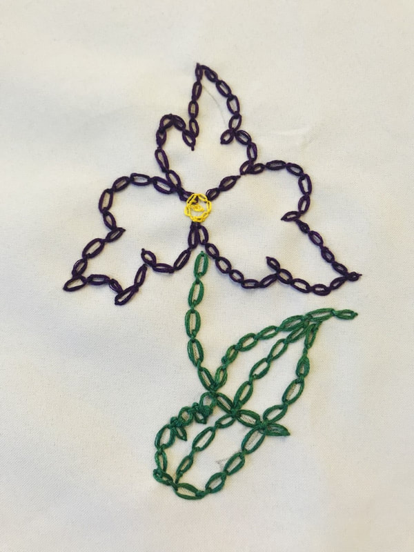 blue, green and yellow chain stitched flower