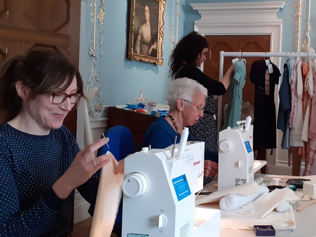 Costume conservators at work in the Dining Room