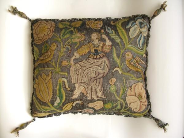 1922.1821 Embroidered linen pincushion and book cushion, Flora among foliage, British, c.1640-1660