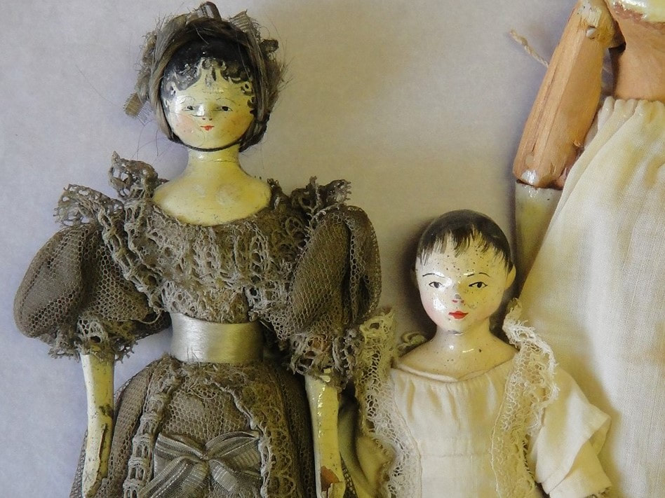 Detail of two 19th century wooden dolls.