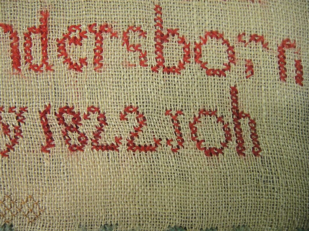 Detail of stitching on linen sampler, probably embroidered by Mary Ann Elizabeth Saunders, 1840-1850.