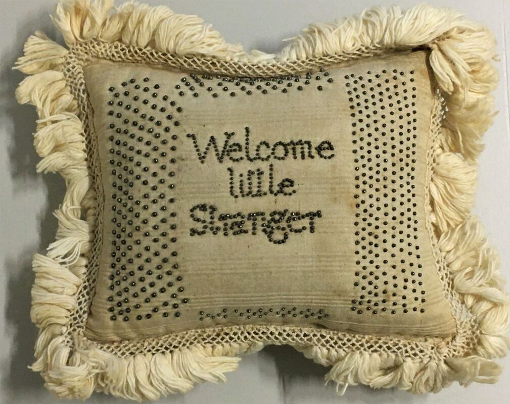 Pincushion, cotton with inscription in pins, 'Welcome little Stranger, MA, CT, 1798'.