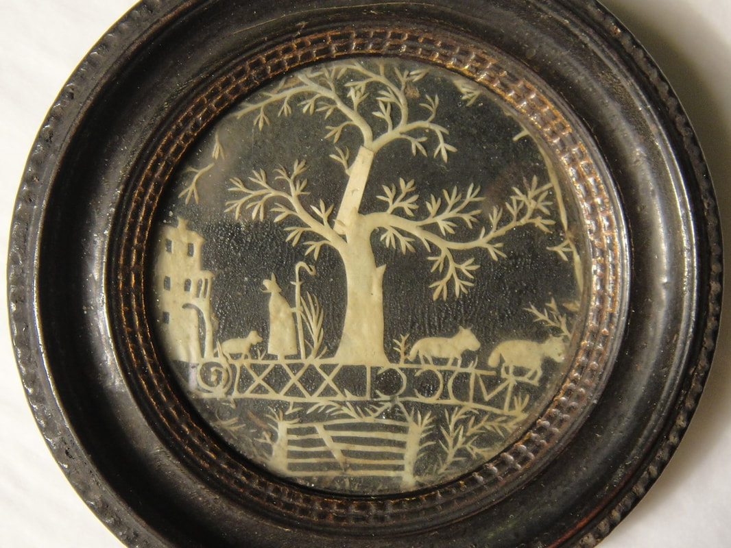 Detail of 19th century cutwork paper picture of a shepherd beneath a tree