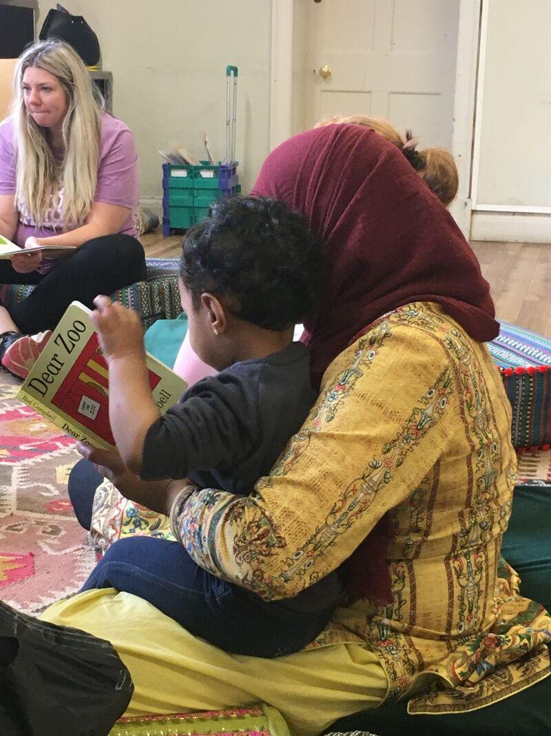Parent and child sitting reading together
