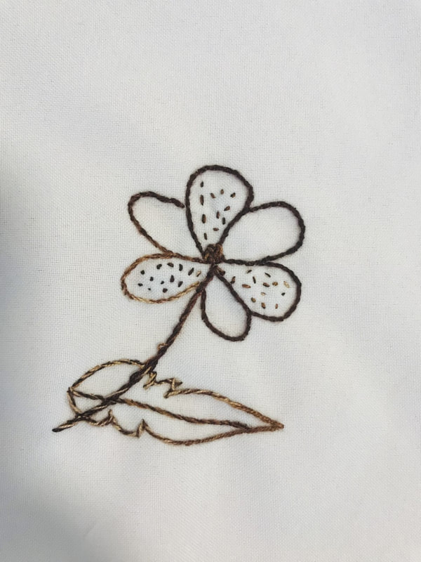 brown stitched outline of flower